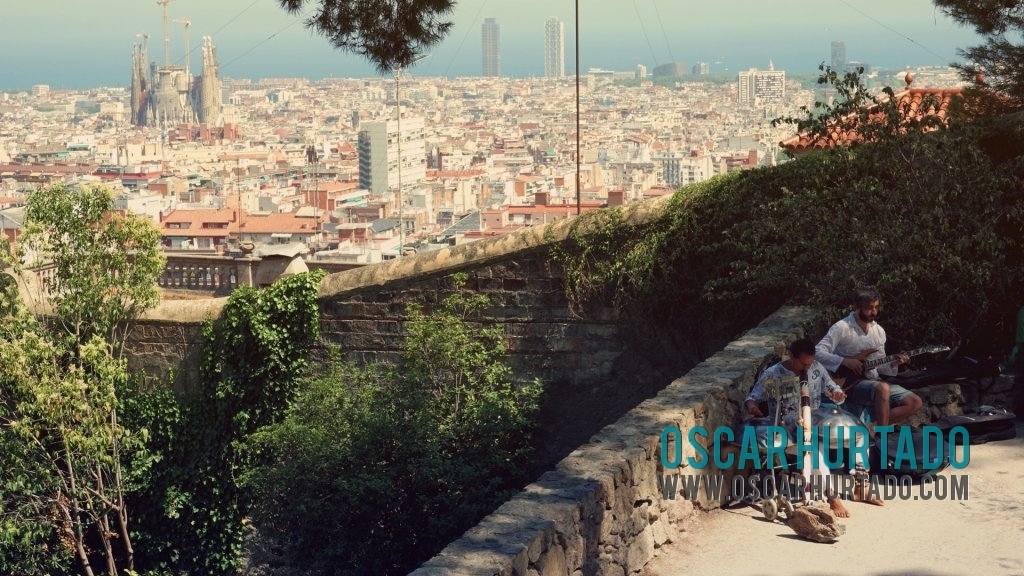 A pair of musicians playing relaxing tunes at Parc Güell during one summer afternoon in Barcelona Spain