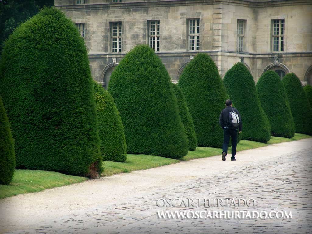 A young tourist walks through the gardens outside of Les Invalides Museum in Paris