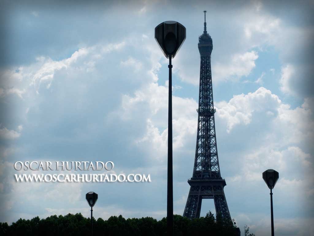 The Eiffel Tower seen from a distance and contrasting against street lamps