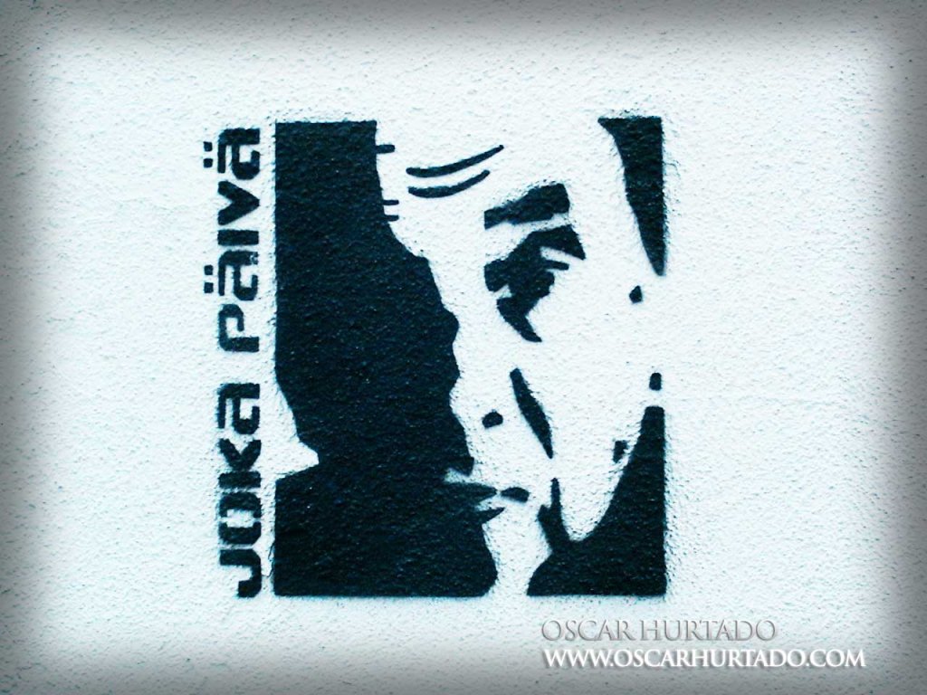 Black minimalistic stencil graffiti by Joka Päivä of a portrait of the Dalai Lama