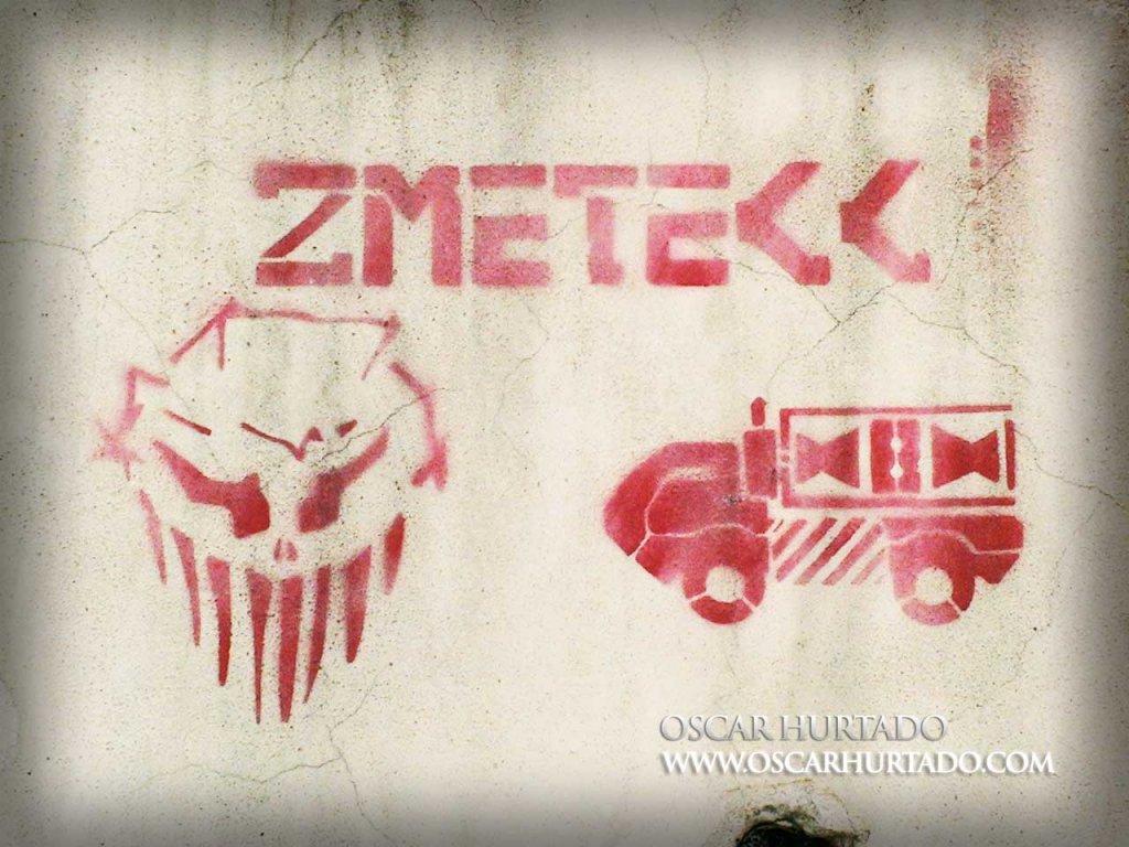 Red graffiti of an alienlike creature next to some bizarre vehicle