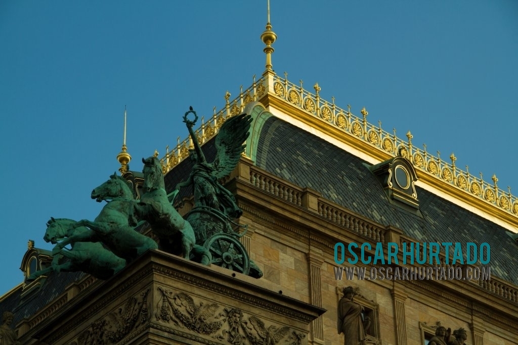 Detail view of the architecture and statues decorating the top section the National Theater in Prague