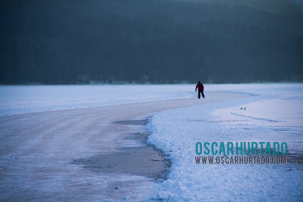 A man enjoys a winter afternoon while ice skating across the frozen Lipno Dam