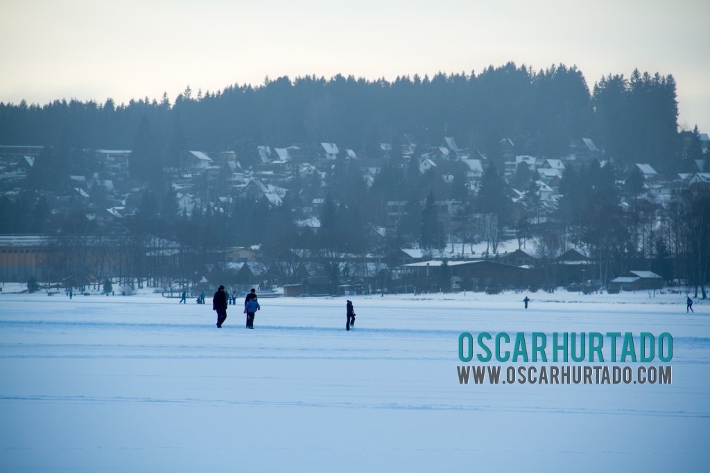 People having fun ice skating during one winter afternoon in Lipno