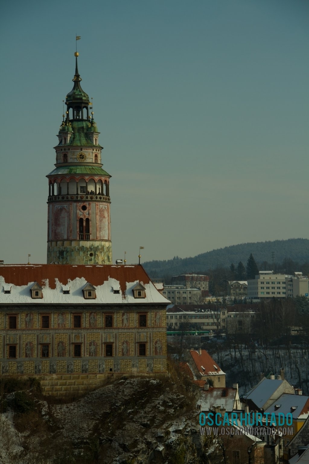 View of the Český Krumlov Castle tower dominating the landscape and the town surroundings during one winter day