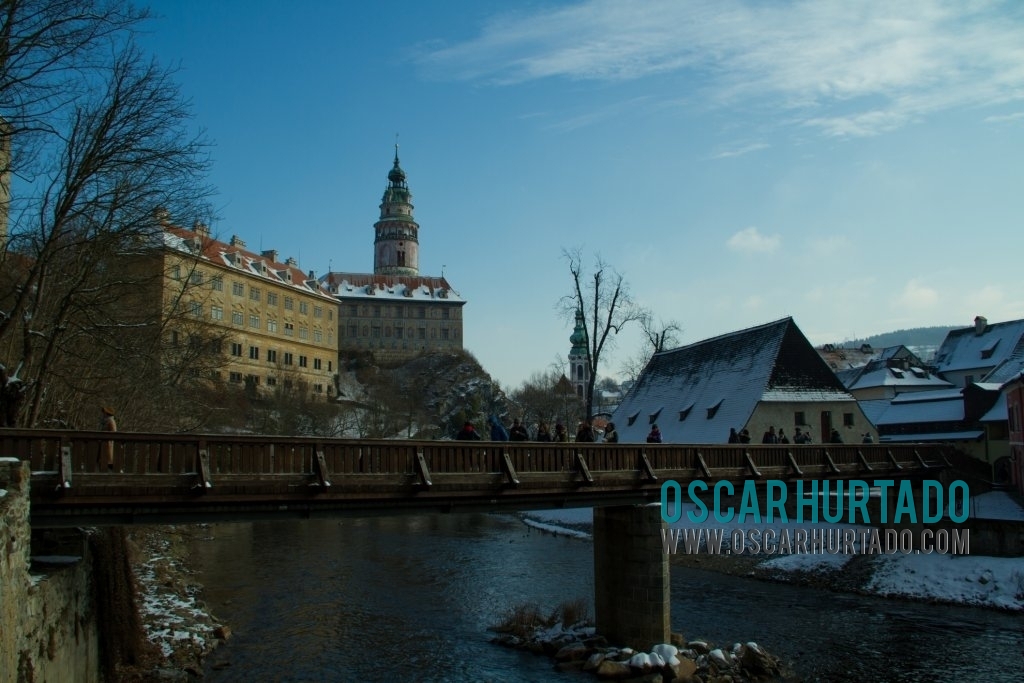 The bridge that crosses the Vltava river and leads to the beautiful and historical town of ÄŒeskÃ½ Krumlov seen on the background
