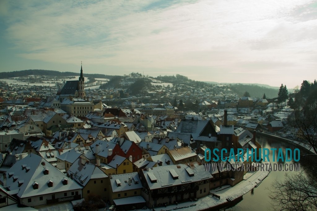 Panoramic view of the colorful and picturesque town of Český Krumlov with its snow rooftops and landscapes surrounded by the majestic Vltava river