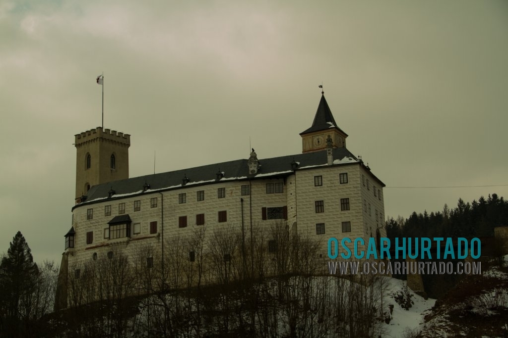 The iconic Castle of Rožmberk seen from a distance during a winter afternoon
