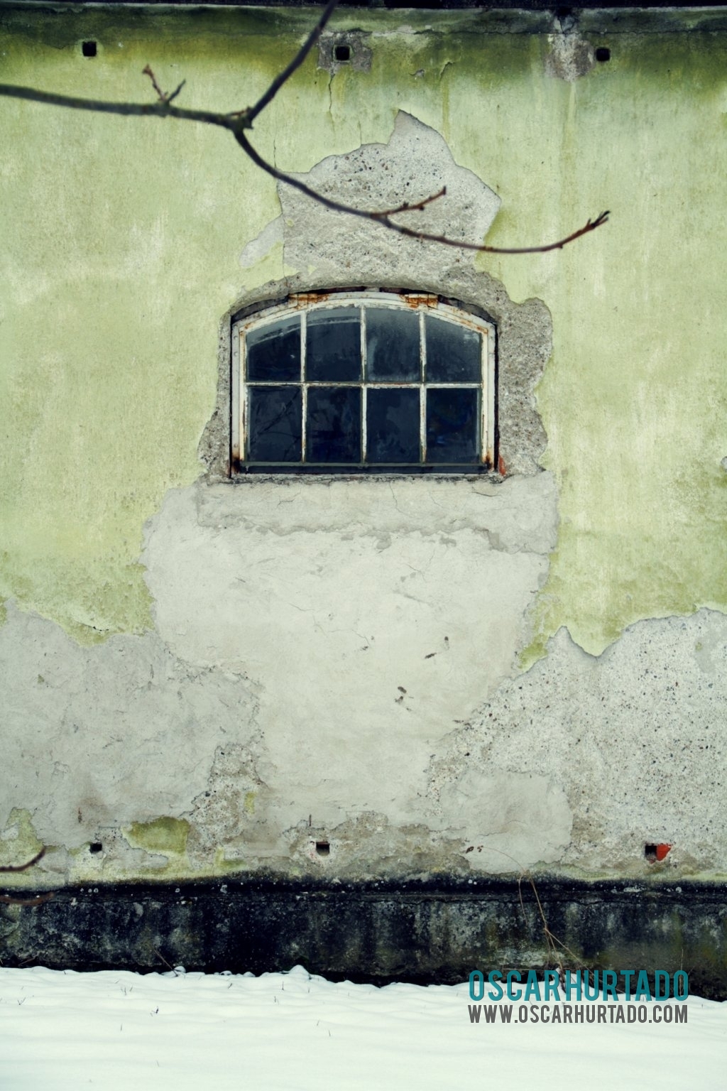 Picturesque old window found immersed in the decaying walls of an abandoned building