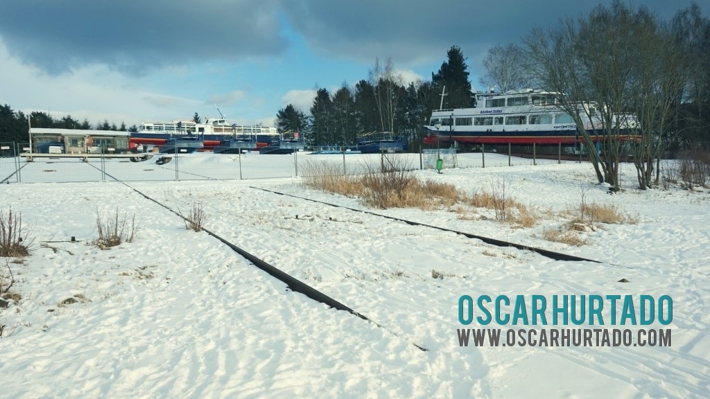Interesting view of the frozen harbor and cargo zone located on the shore of the Lipno lake