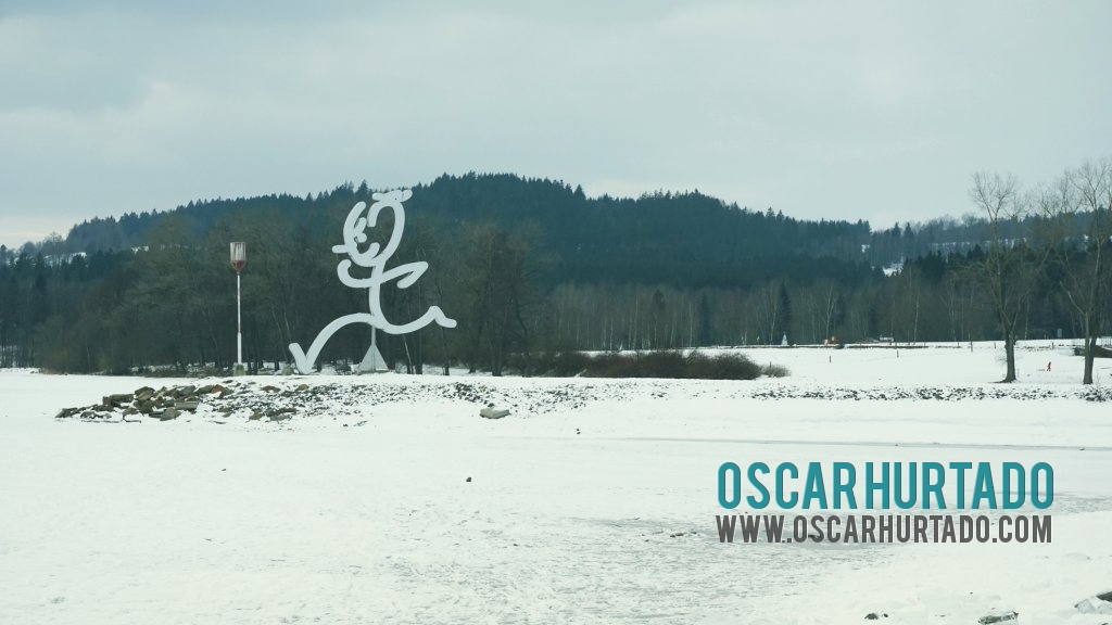 Distant view of an iconic figure situated on the shores of the Lipno lake