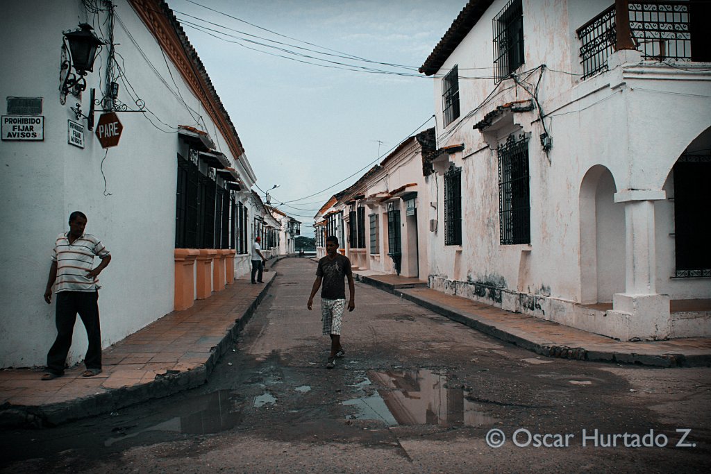 Locals wandering and walking around the colonial streets of Mompox during one rainy afternoon