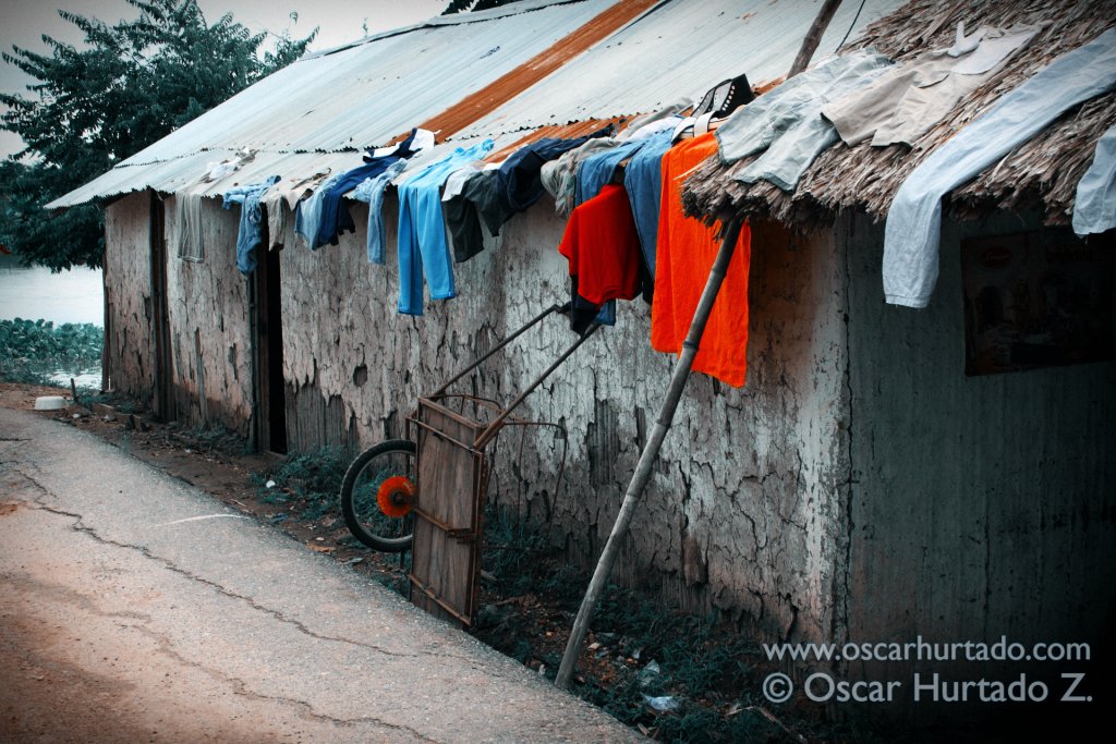 A collection of clothes drying up on the roof of a home by the flooded shores of the Magdalena river