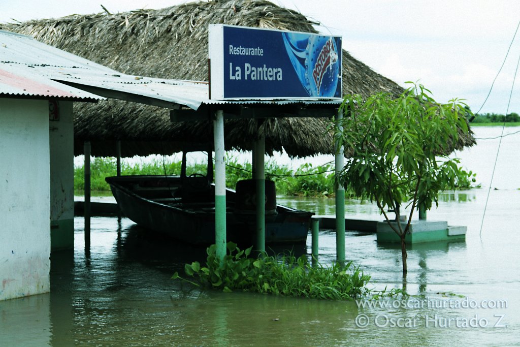 A boat floats inside a flooded restaurant during the rainy season hitting the Magdalena region