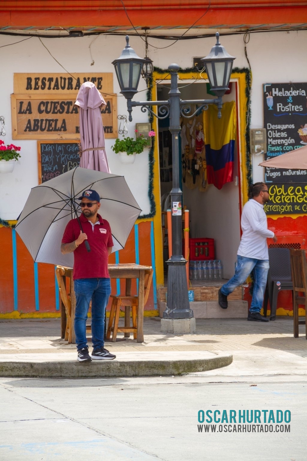 Picturesque scene of a man holding a parasol to protect himself from the sun during morning hours in Salento
