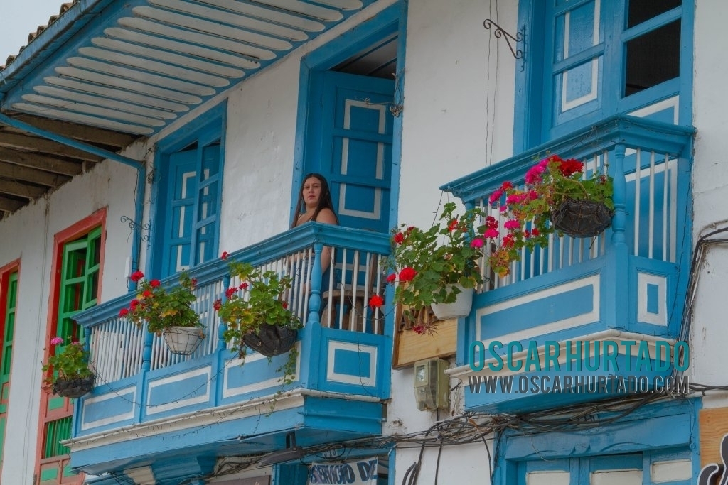 A girl made her entrance while taking a shot of this colorful balcony in Salento, Quindío